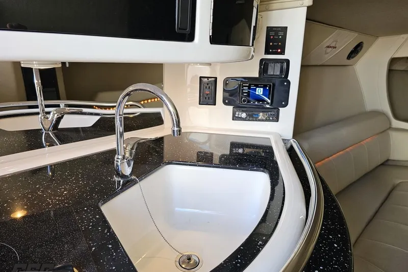 Slide: The Image of Luxurious 2009 Fountain 47 Lightning yacht interior with modern kitchen and entertainment system. - 96