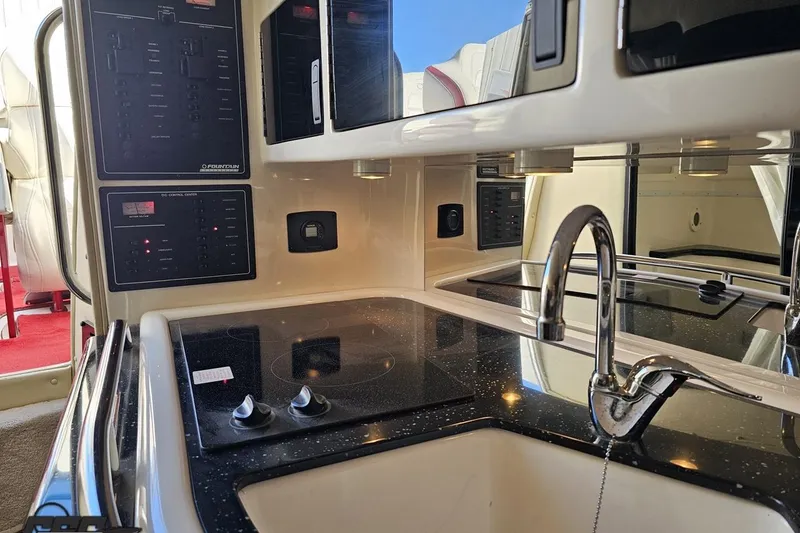 Slide: The Image of 2009 Fountain 47 Lightning boat interior with modern kitchen and control panels. - 99