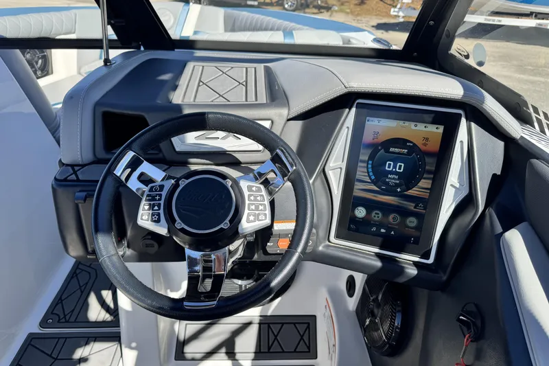 Slide: The Image of 2021 Tigé 21ZX boat dashboard with touchscreen display and steering wheel. - 10