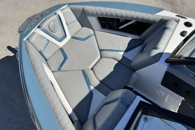 Slide: The Image of 2021 Tigé 21ZX boat interior with gray and blue cushioned seating. - 12