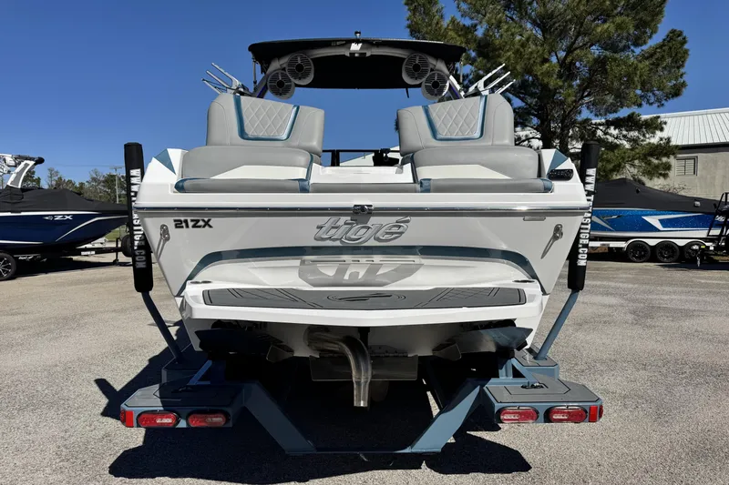 Slide: The Image of 2021 Tigé 21ZX boat rear view, featuring sleek design and dual seating. - 4