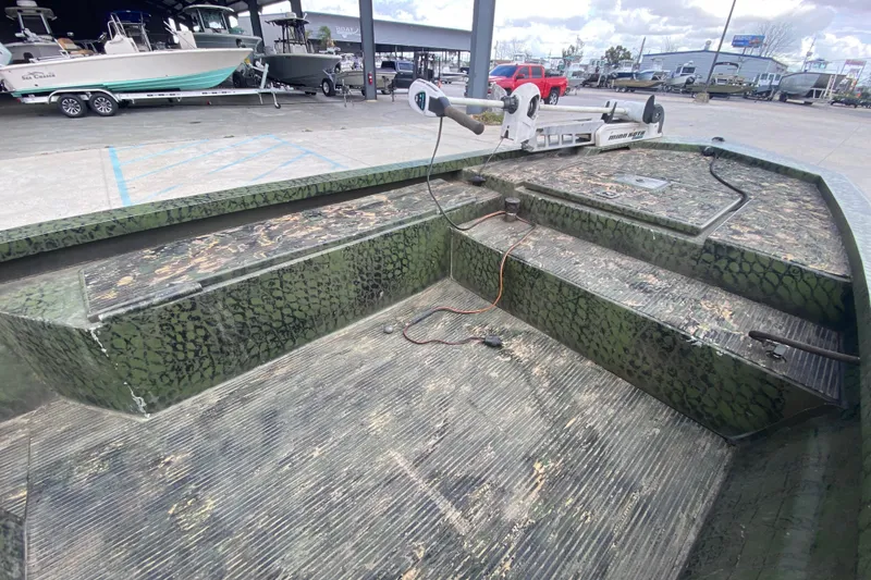 Slide: The Image of Custom 2016 Charles Leonard Skiff with camouflage pattern, docked at a marina. - 11