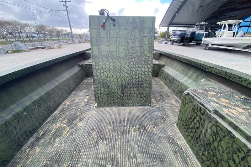 Slide: The Image of Custom 2016 Charles Leonard Skiff with camouflage pattern, docked near other boats. - 13