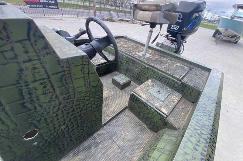 Slide: The Image of Custom 2016 Charles Leonard Skiff with camouflage design and Mercury 150 outboard motor. - 14