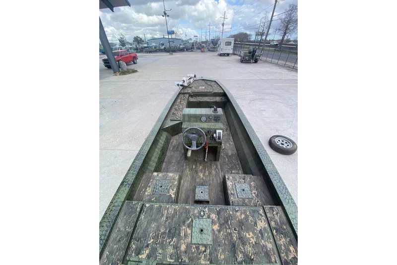 Slide: The Image of Custom 2016 Charles Leonard Skiff with camouflage design, parked outdoors. - 17