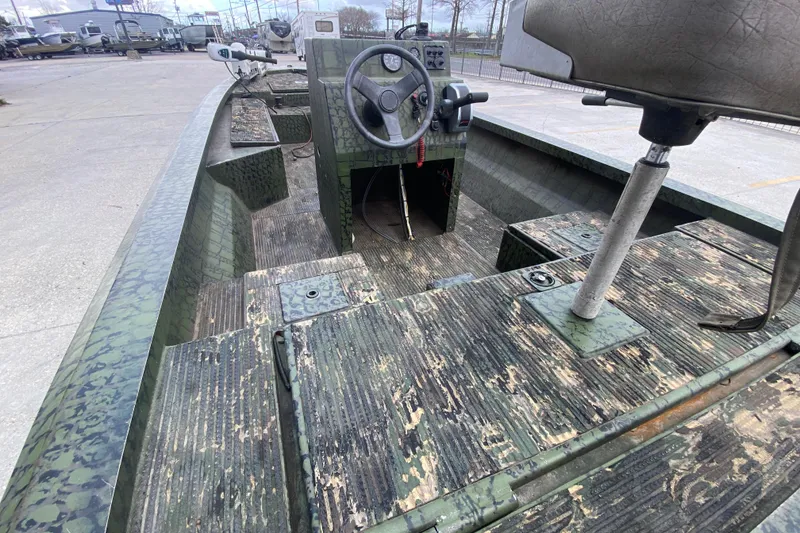 Slide: The Image of Interior of a 2016 Custom Charles Leonard Skiff with camouflage design and steering console. - 18