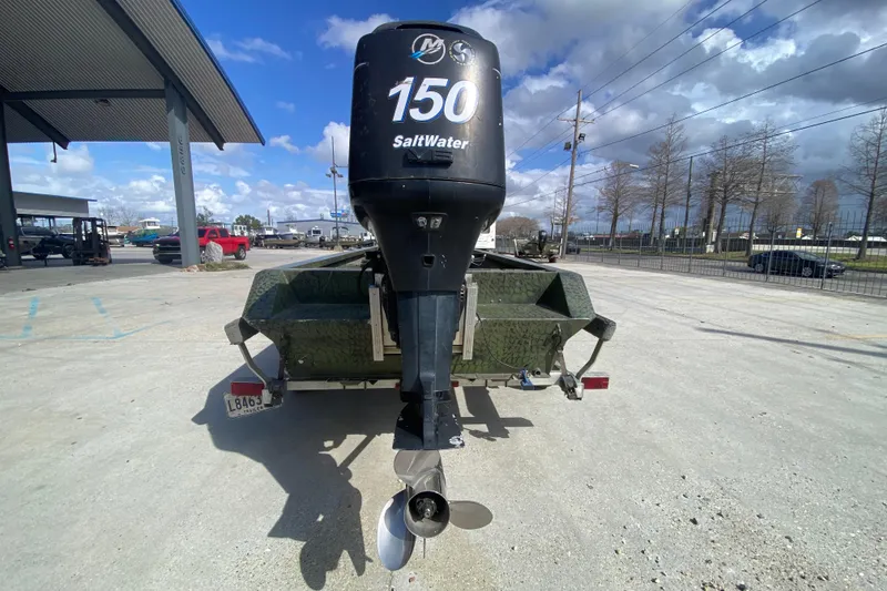 Slide: The Image of Custom Charles Leonard Skiff 2016 with 150 SaltWater outboard motor in parking lot. - 4