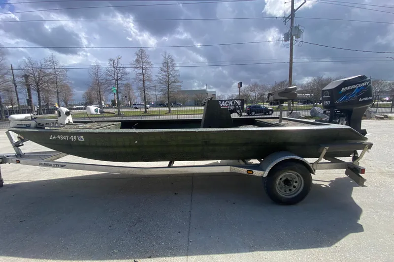 Slide: The Image of Custom 2016 Charles Leonard Skiff on trailer with Mercury outboard motor, parked outdoors. - 6