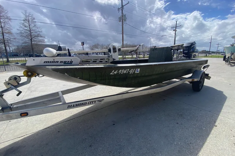 Slide: The Image of Custom 2016 Charles Leonard Skiff on trailer, featuring Minn Kota motor, under cloudy sky. - 7
