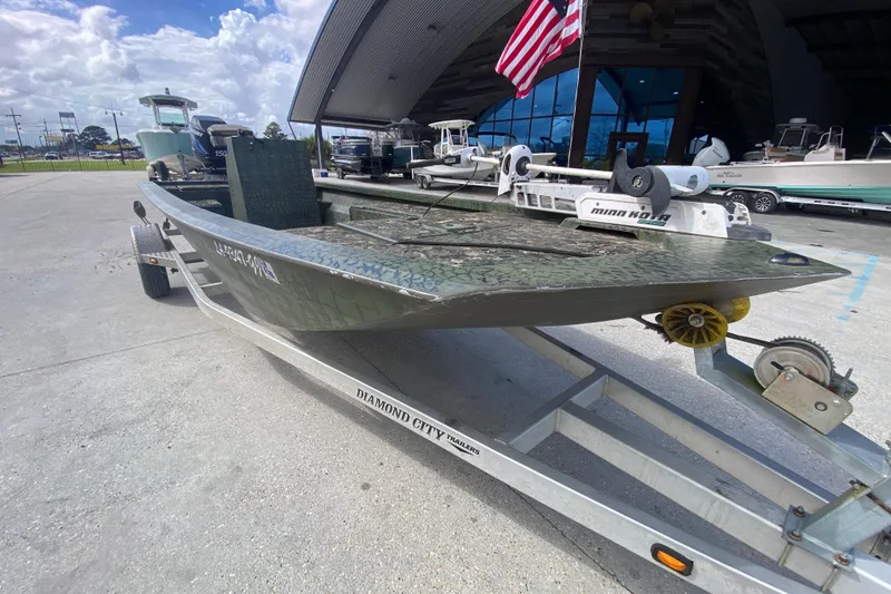 Slide: The Image of Custom 2016 Charles Leonard Skiff on trailer, featuring camouflage design and American flag. - 9