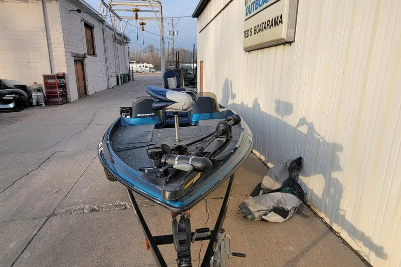 Slide: The Image of 2001 Ranger 518DVX Comanche boat parked outside a building on a sunny day. - 12
