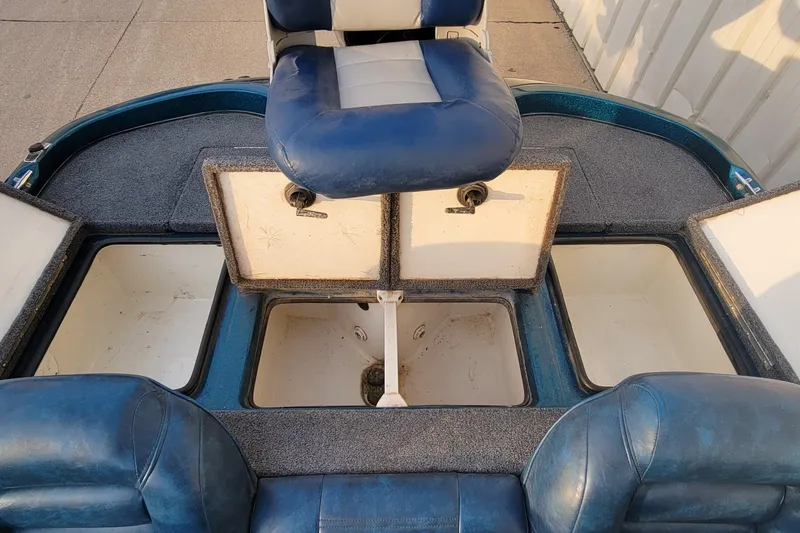 Slide: The Image of 2001 Ranger 518DVX Comanche boat interior with open storage compartments and blue seating. - 14