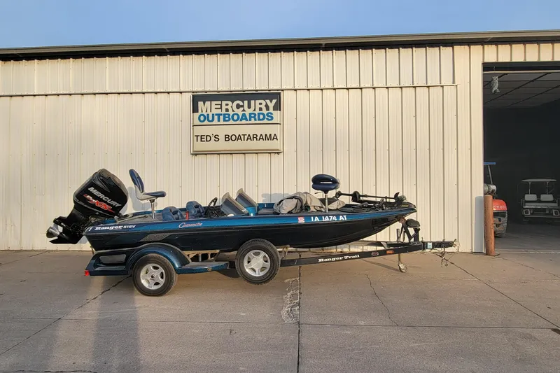 Slide: The Image of 2001 Ranger 518DVX Comanche boat on trailer outside Mercury Outboards shop. - 3