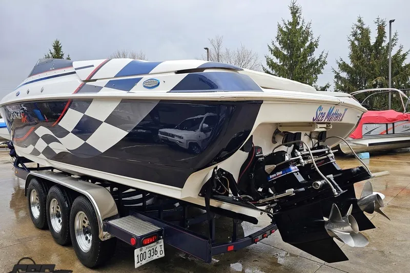 Slide: The Image of 2000 Donzi 33 ZX speedboat with checkered flag design on a trailer. - 17