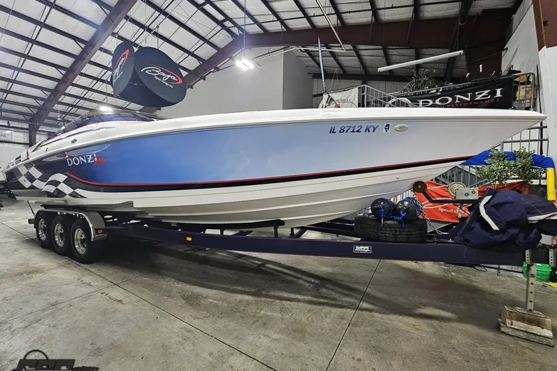 Slide: The Image of 2000 Donzi 33 ZX speedboat on trailer in indoor storage facility. - 24