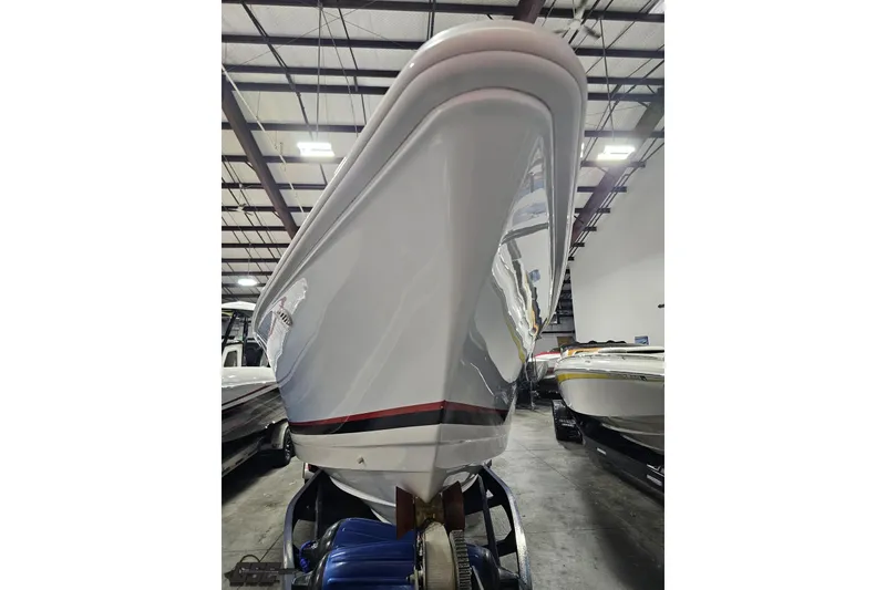 Slide: The Image of 2000 Donzi 33 ZX boat in storage, showcasing sleek hull design. - 27