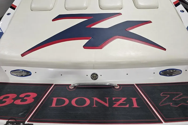 Slide: The Image of Rear view of a 2000 Donzi 33 ZX boat with logo and branding. - 34