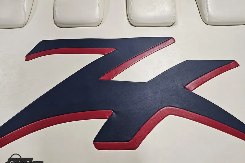 Slide: The Image of Donzi 33 ZX 2000 logo on white leather upholstery with red and blue accents. - 35
