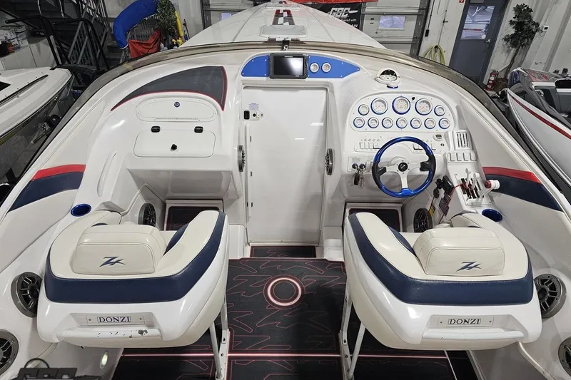 Slide: The Image of 2000 Donzi 33 ZX boat cockpit with dual seats, steering wheel, and control panel. - 39