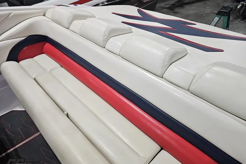 Slide: The Image of 2000 Donzi 33 ZX boat interior with white, red, and blue seating. - 40