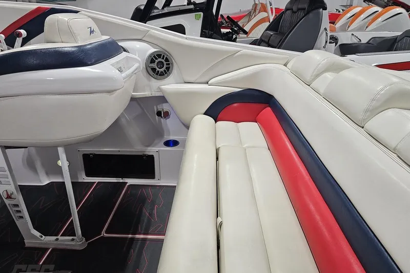Slide: The Image of Interior of a 2000 Donzi 33 ZX boat with white, red, and blue seating. - 41