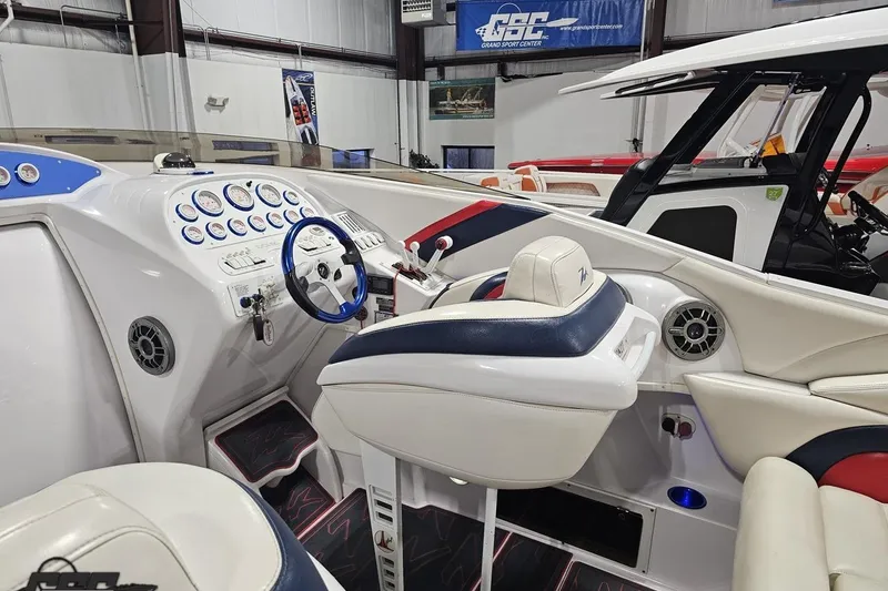 Slide: The Image of 2000 Donzi 33 ZX boat interior with white and blue seating, dashboard, and steering wheel. - 42