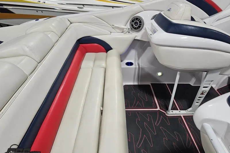 Slide: The Image of 2000 Donzi 33 ZX boat interior with white, red, and blue seating, and modern dashboard. - 43