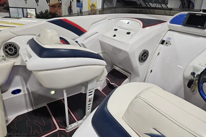 Slide: The Image of Interior of a 2000 Donzi 33 ZX boat, featuring white and blue seating. - 44
