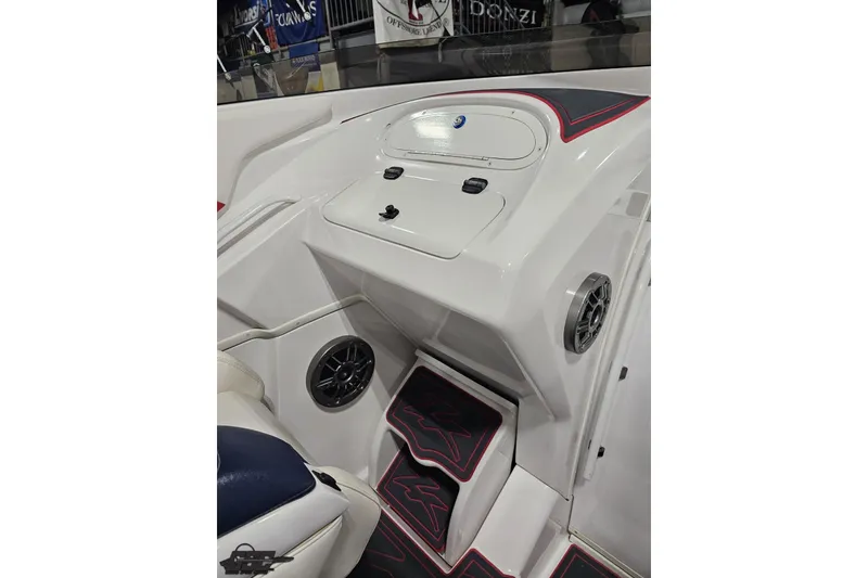 Slide: The Image of Interior of a 2000 Donzi 33 ZX boat, featuring sleek white design and speaker system. - 47