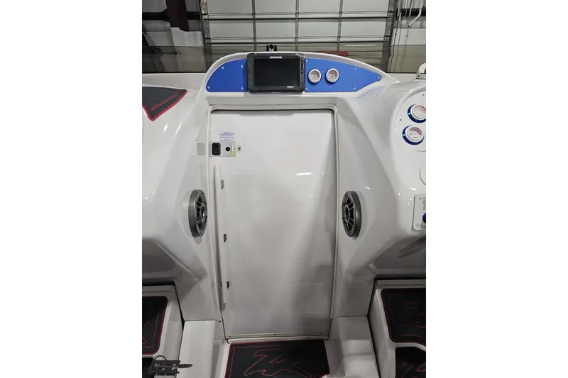 Slide: The Image of 2000 Donzi 33 ZX boat dashboard with gauges and navigation system. - 48