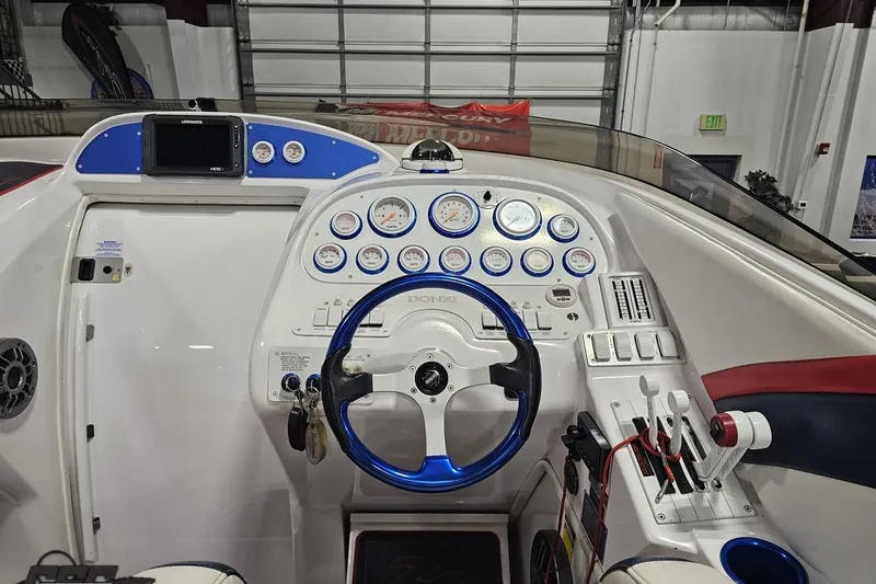 Slide: The Image of Cockpit of a 2000 Donzi 33 ZX boat with steering wheel and gauges. - 49