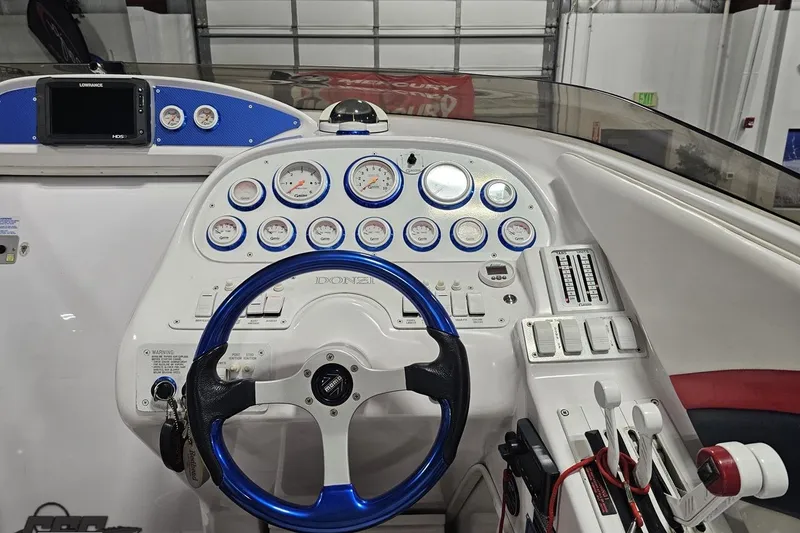 Slide: The Image of Cockpit of a 2000 Donzi 33 ZX boat with gauges and steering wheel. - 50