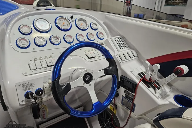 Slide: The Image of Cockpit of a 2000 Donzi 33 ZX boat with gauges and steering wheel. - 53