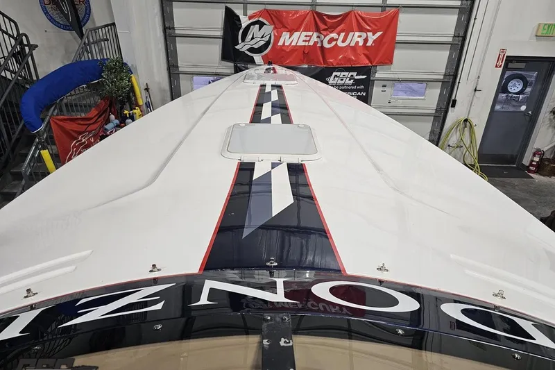 Slide: The Image of 2000 Donzi 33 ZX boat in garage with Mercury banner overhead. - 56