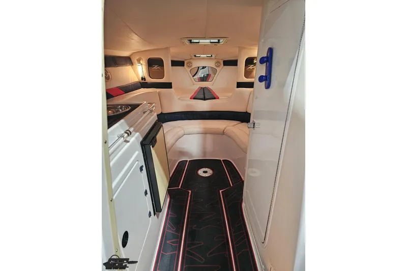 Slide: The Image of Interior of 2000 Donzi 33 ZX boat with modern seating and compact kitchenette. - 58