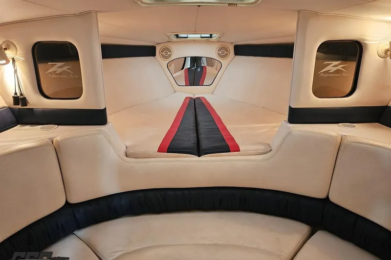 Slide: The Image of Interior of a 2000 Donzi 33 ZX boat, featuring beige and black seating. - 64