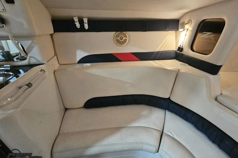 Slide: The Image of Interior of a 2000 Donzi 33 ZX boat, featuring beige and navy seating. - 66