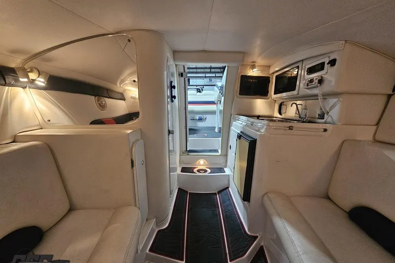 Slide: The Image of Interior of a 2000 Donzi 33 ZX boat, featuring seating and kitchenette. - 67