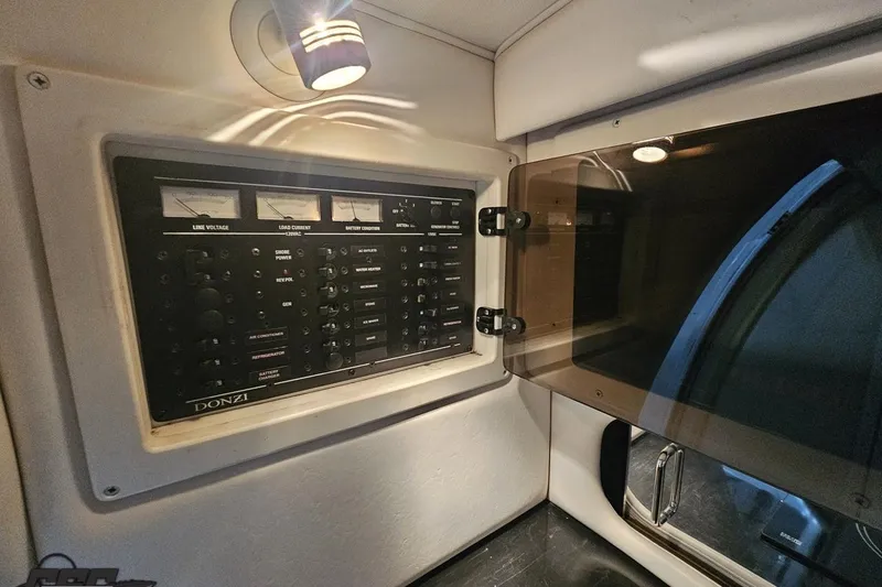 Slide: The Image of Control panel inside 2000 Donzi 33 ZX boat, featuring gauges and switches. - 70
