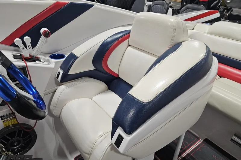 Slide: The Image of 2000 Donzi 33 ZX boat interior with white, blue, and red seating and controls. - 76
