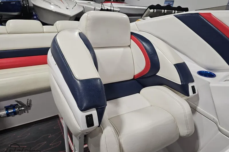 Slide: The Image of 2000 Donzi 33 ZX boat interior with white, blue, and red seating. - 77