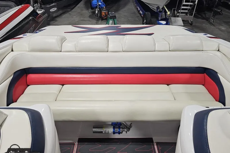 Slide: The Image of Interior of 2000 Donzi 33 ZX boat with white, red, and blue seating. - 78