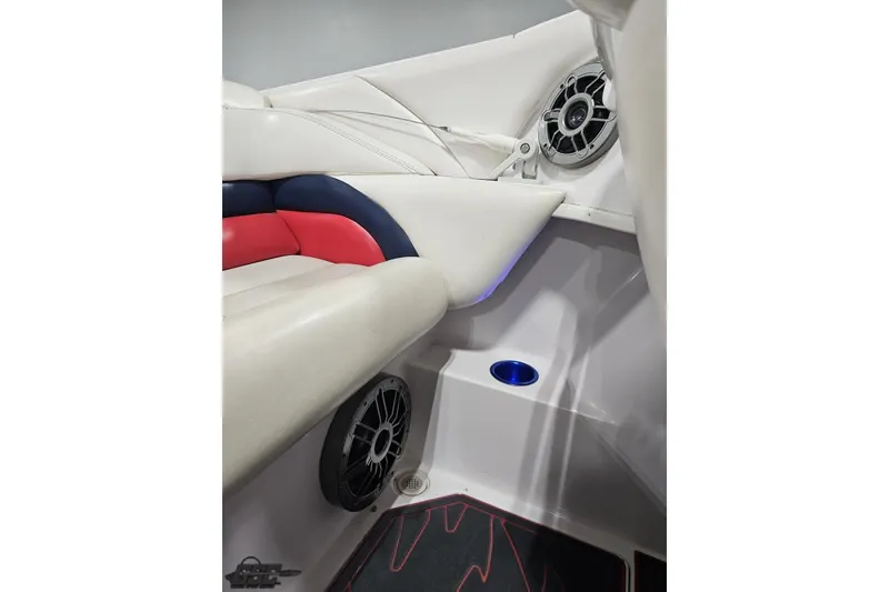 Slide: The Image of Interior of 2000 Donzi 33 ZX boat with white and red seating, speaker, and cup holder. - 81