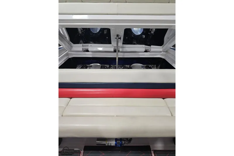 Slide: The Image of 2000 Donzi 33 ZX boat interior with open engine compartment, featuring white and red seating. - 87