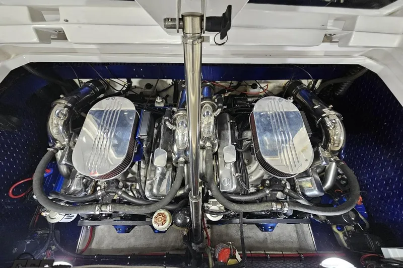 Slide: The Image of Twin engines of a 2000 Donzi 33 ZX boat, showcasing polished components. - 90
