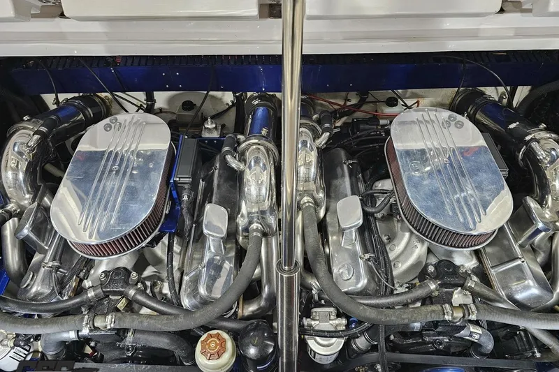 Slide: The Image of Twin engines of a 2000 Donzi 33 ZX boat, showcasing polished components. - 91