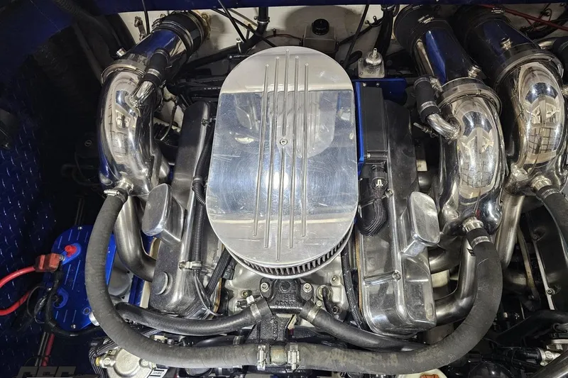 Slide: The Image of Engine of a 2000 Donzi 33 ZX boat, featuring polished metal components. - 92