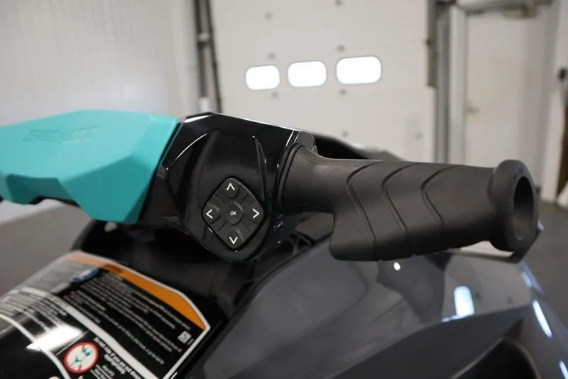 Slide: The Image of 2025 Sea-Doo GTR 230 handlebar with control buttons in a garage setting. - 17