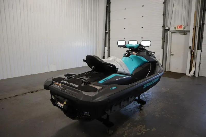 Slide: The Image of 2025 Sea-Doo GTR 230 jet ski in a garage, showcasing sleek design and vibrant colors. - 3