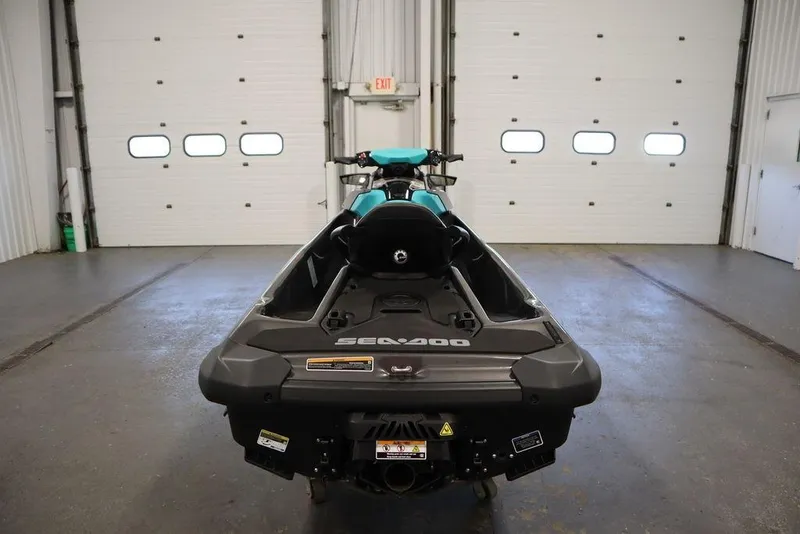 Slide: The Image of 2025 Sea-Doo GTR 230 jet ski in a garage, rear view. - 4
